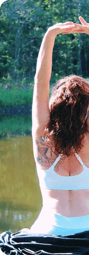 Woman stretching by peaceful lake