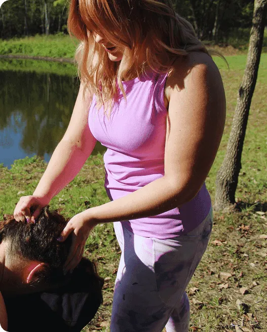Therapist giving head massage outdoors