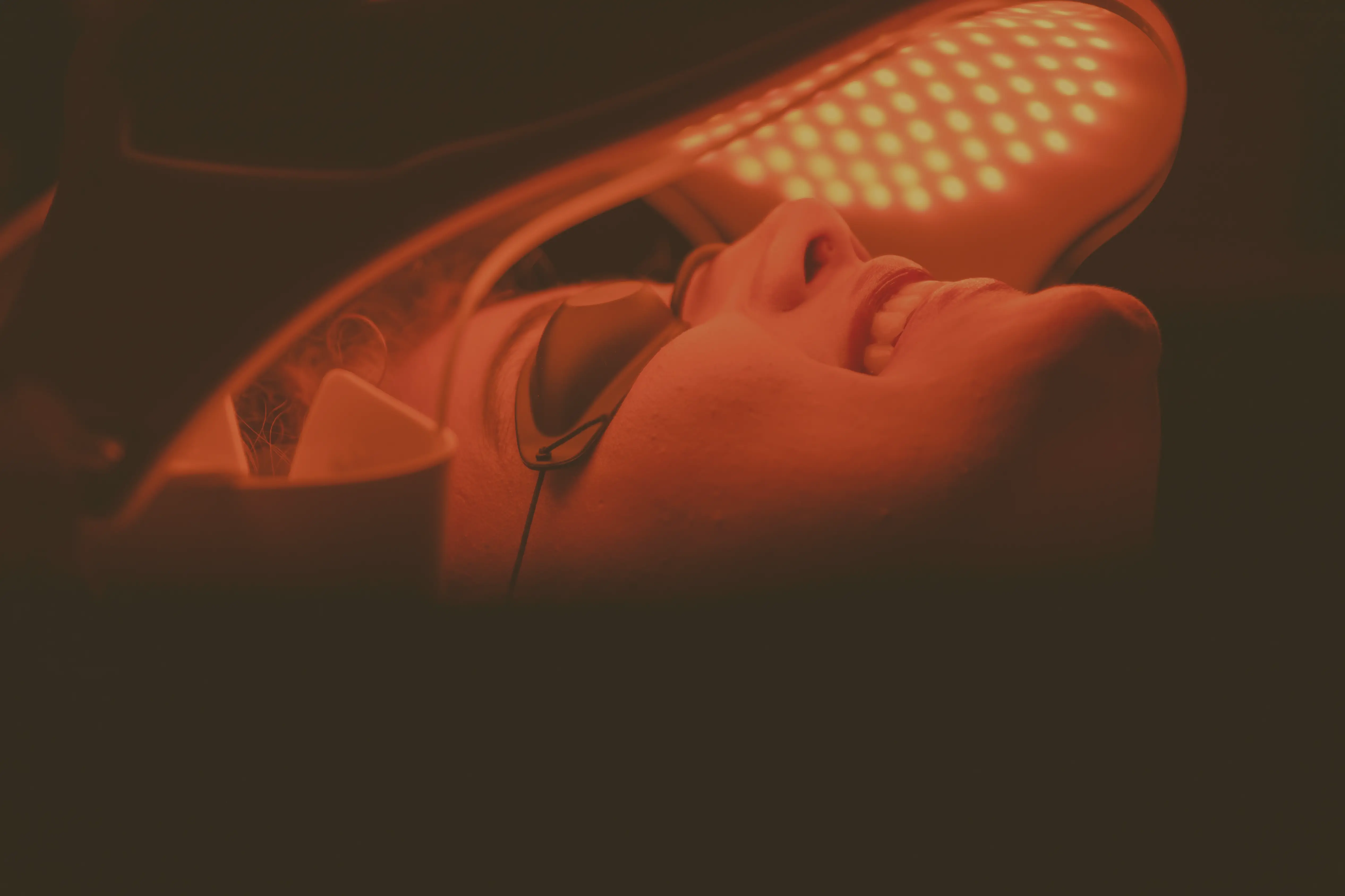 Client receiving red light therapy treatment for pain relief and healing